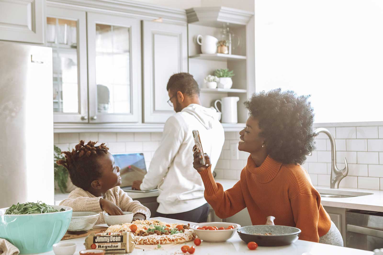 Family at home using smart controls to manage electric heating around time-of-use tariffs