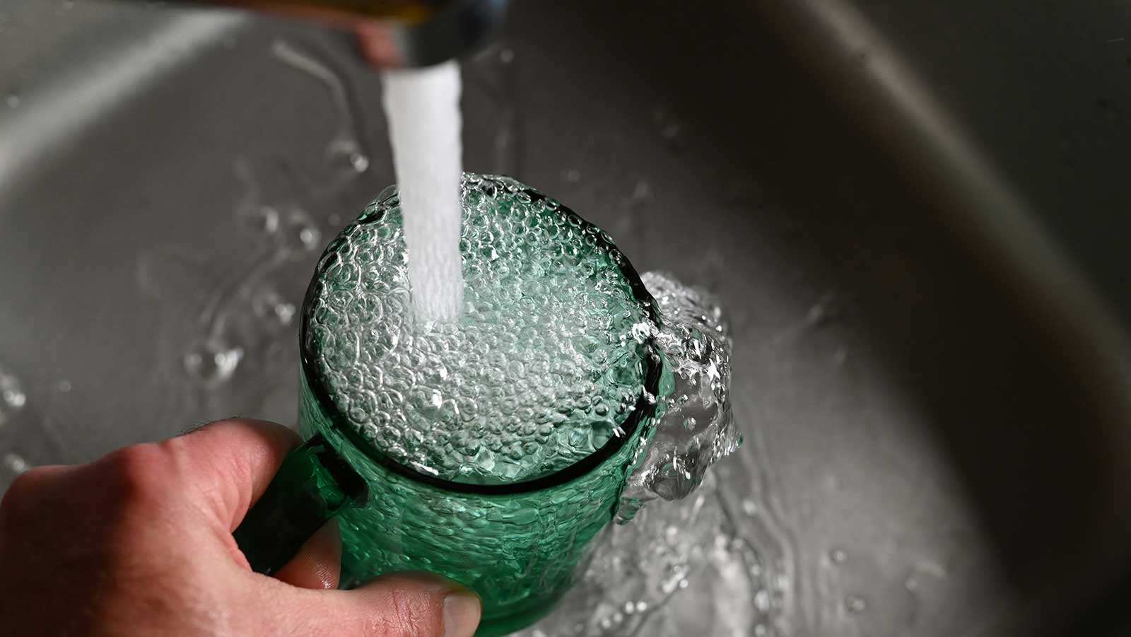 Pouring tap water into a glass