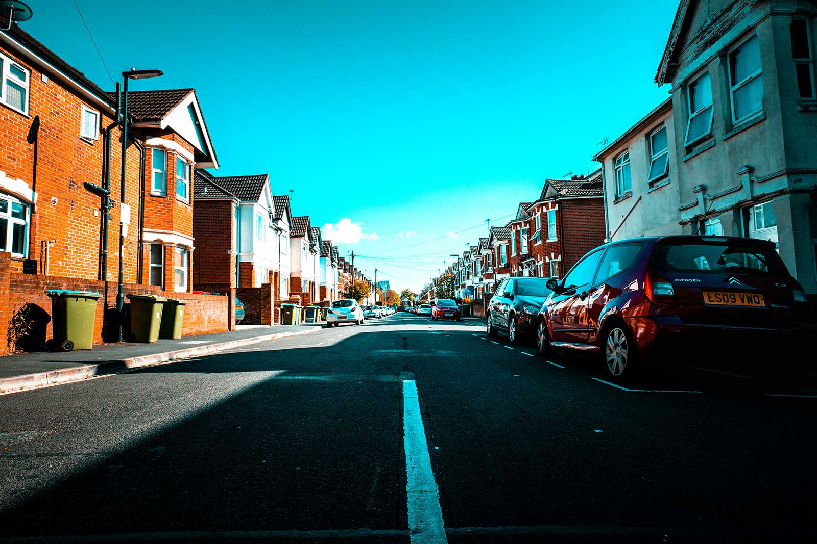 A row of traditional UK brick terraced houses, representing typical private rental properties requiring EPC C heating upgrades.