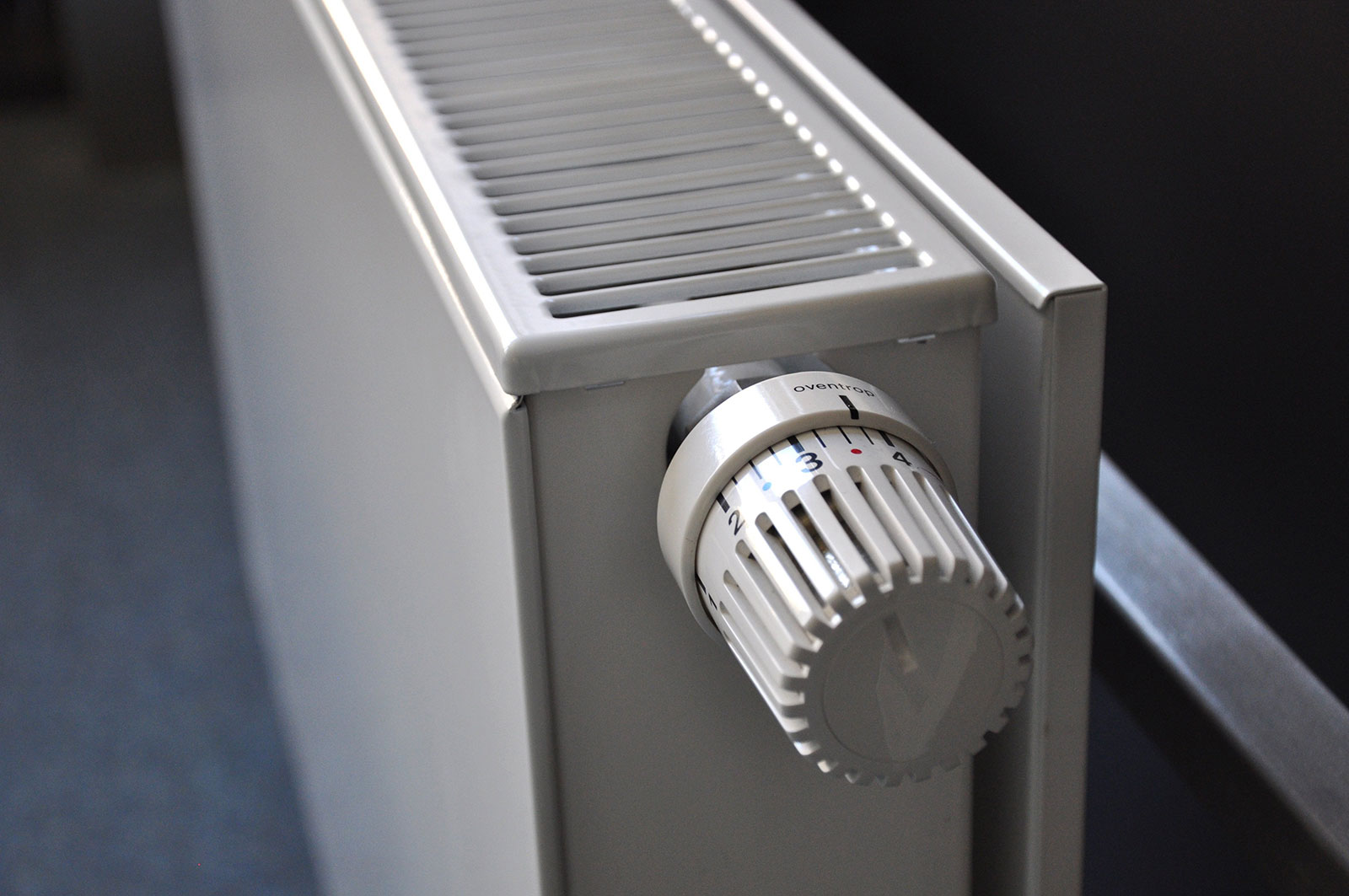 Close-up of a radiator thermostat valve, representing common heating problems after summer.